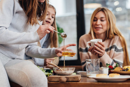 Woman mixing honey and granola in a bowl