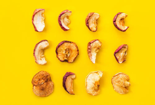 Freeze dried apples on a bright yellow background