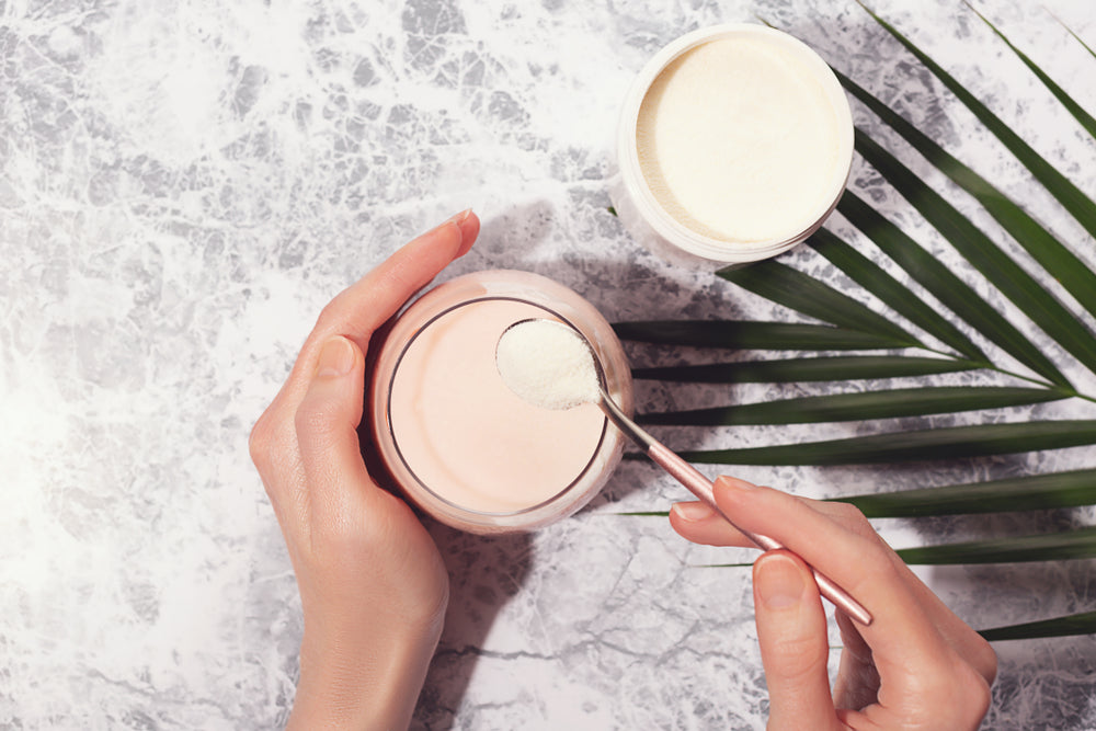 Woman pouring collagen powder into her drink