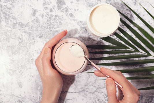 Woman pouring collagen powder into her drink