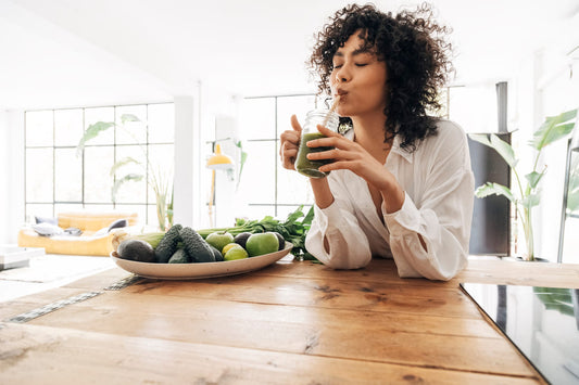 Young women drinking a freen smoothie